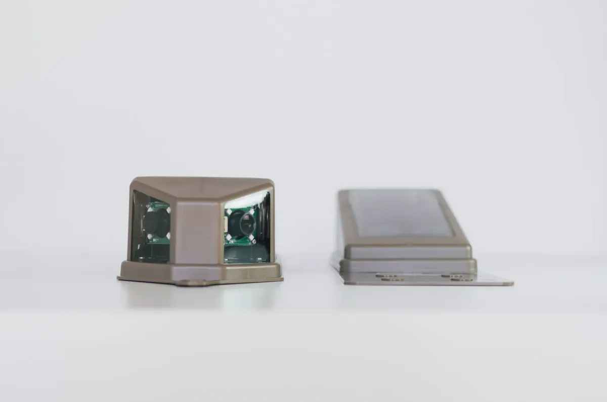 Two solar roof camera modules in UV-resistant housings, one showing its twin camera windows